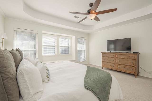 bedroom with carpet, visible vents, a raised ceiling, and baseboards