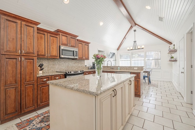 kitchen with light tile patterned floors, appliances with stainless steel finishes, a peninsula, an inviting chandelier, and backsplash