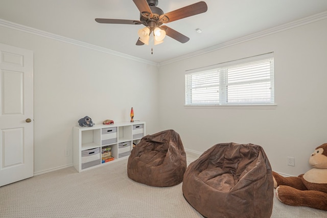 living area with ceiling fan, carpet, baseboards, and crown molding