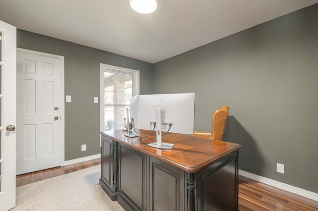 home office with light wood finished floors and baseboards