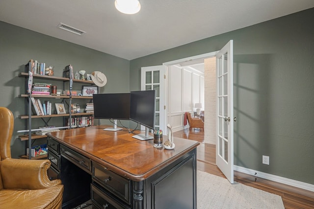 office space with french doors, light wood-type flooring, visible vents, and baseboards