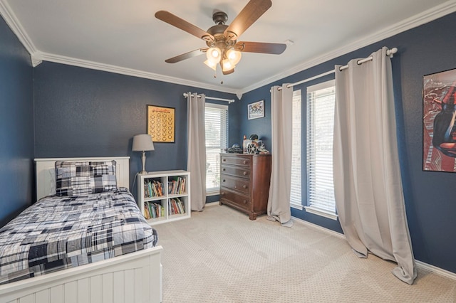 carpeted bedroom with baseboards, a ceiling fan, and crown molding