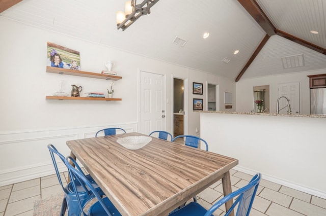 dining area featuring vaulted ceiling with beams, light tile patterned floors, visible vents, and wainscoting