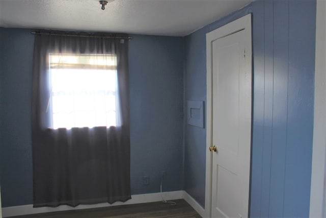 unfurnished room featuring dark hardwood / wood-style floors and a textured ceiling