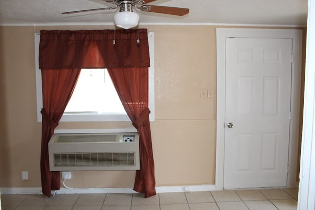 interior space featuring a textured ceiling, heating unit, ceiling fan, an AC wall unit, and light tile patterned flooring