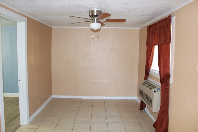 tiled empty room featuring ceiling fan, ornamental molding, and a textured ceiling