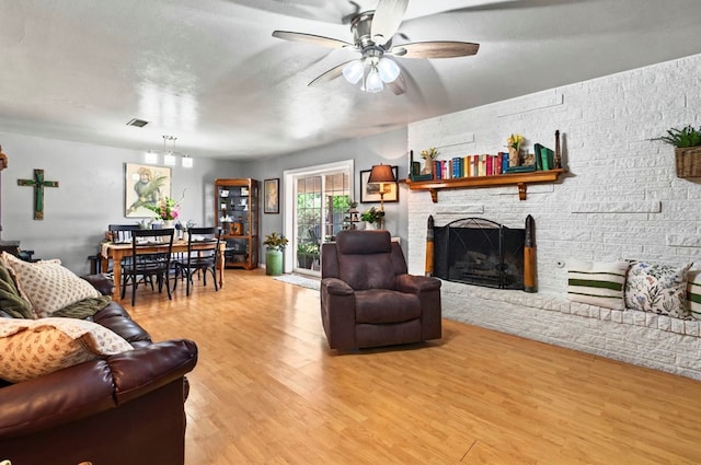 3216 W Dengar Ave, Midland, TX 79705 - living area featuring a ceiling fan, light wood-style flooring, and a fireplace