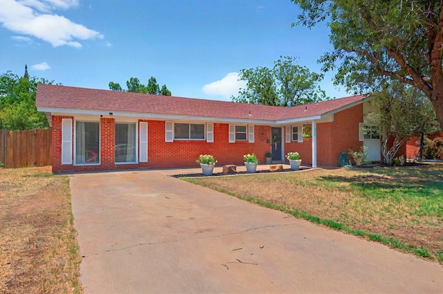 3216 W Dengar Ave, Midland, TX 79705 - ranch-style house with concrete driveway and brick siding