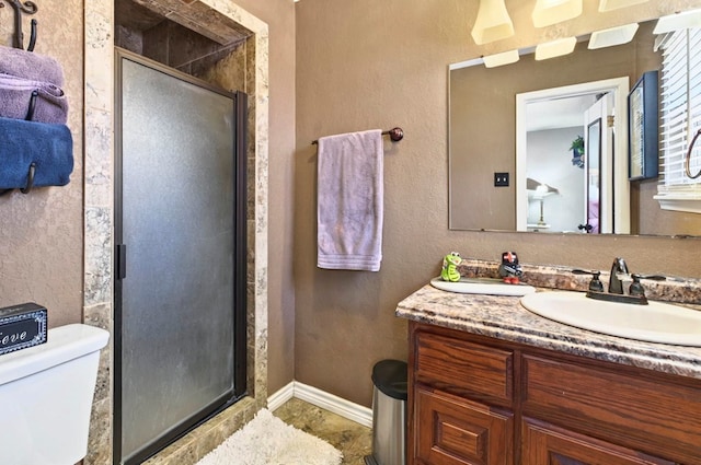 3216 W Dengar Ave, Midland, TX 79705 - bathroom featuring vanity, toilet, a stall shower, and baseboards