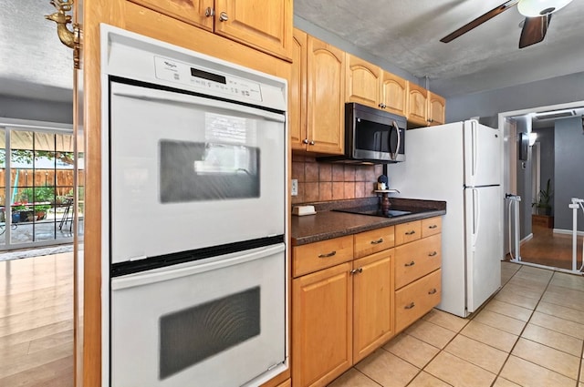 3216 W Dengar Ave, Midland, TX 79705 - kitchen featuring white appliances, a ceiling fan, light tile patterned floors, and backsplash