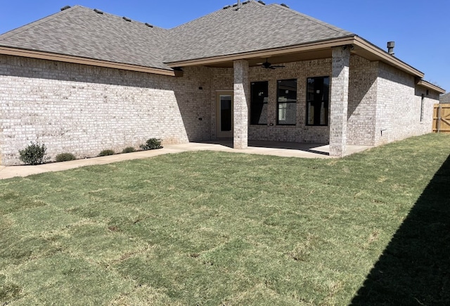 rear view of property with a patio area, brick siding, roof with shingles, and ceiling fan