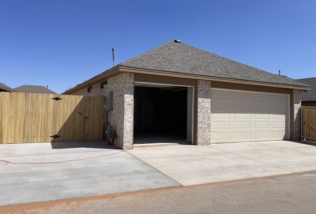 garage featuring a gate and fence