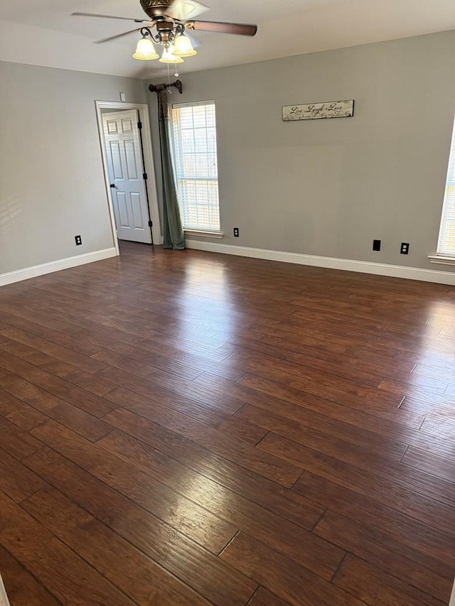 spare room featuring ceiling fan and dark wood-type flooring