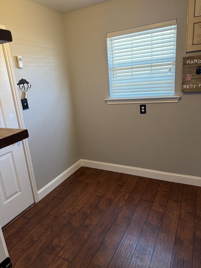 spare room with dark wood-type flooring