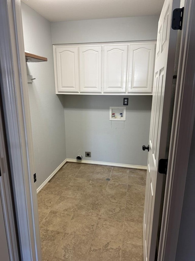 clothes washing area with washer hookup, electric dryer hookup, and cabinets