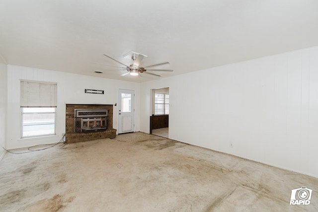 unfurnished living room featuring a wealth of natural light and ceiling fan