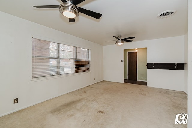 carpeted spare room with ceiling fan