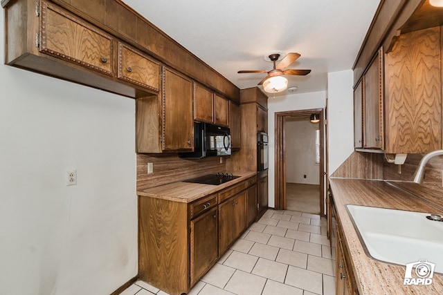 kitchen featuring tasteful backsplash, ceiling fan, sink, and black appliances