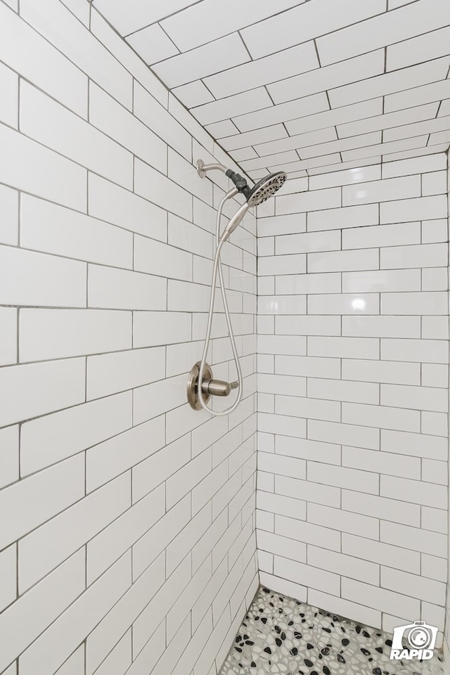 bathroom with a tile shower