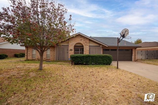 ranch-style home featuring a garage and a front yard