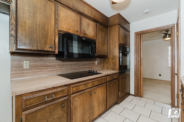 kitchen with tasteful backsplash, ceiling fan, light colored carpet, and black appliances