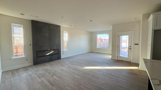 unfurnished living room featuring light hardwood / wood-style floors