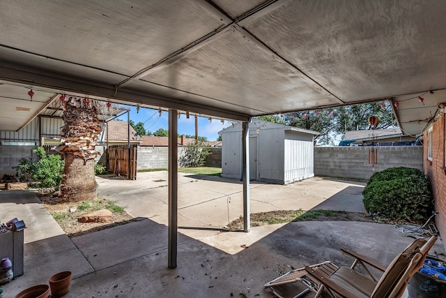 view of patio / terrace with a storage shed, an outbuilding, and a fenced backyard