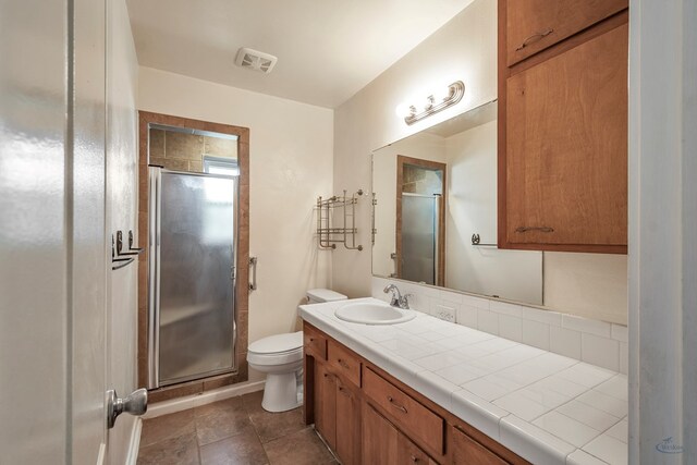 full bath with toilet, a stall shower, visible vents, and vanity