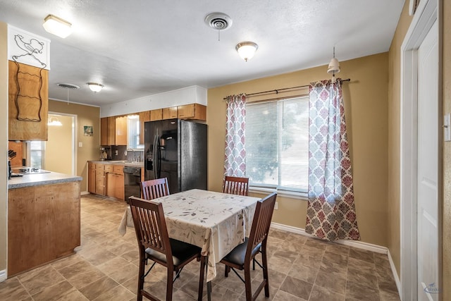 dining space with baseboards and visible vents