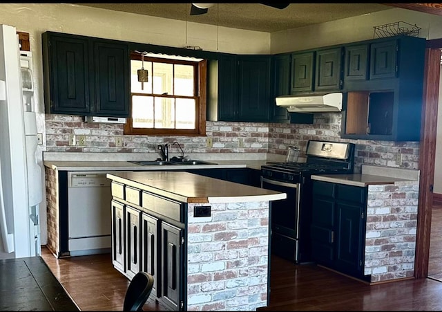 kitchen featuring a center island, stainless steel range with gas stovetop, a sink, dishwasher, and under cabinet range hood