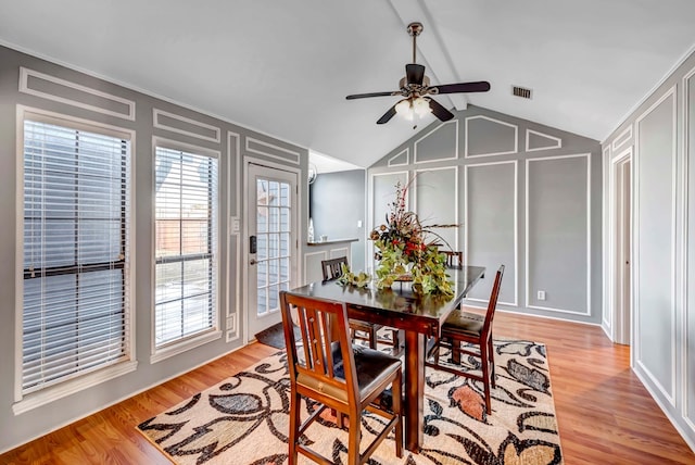 dining room featuring ceiling fan, light hardwood / wood-style flooring, and vaulted ceiling