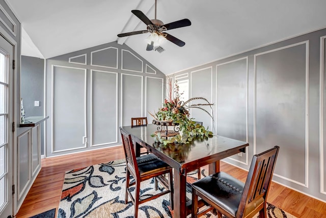 dining space with a wealth of natural light, ceiling fan, light hardwood / wood-style floors, and vaulted ceiling