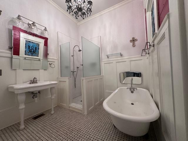 2311 30th St, Snyder, TX 79549 - bathroom featuring a decorative wall, ornamental molding, a stall shower, wainscoting, and tile patterned floors