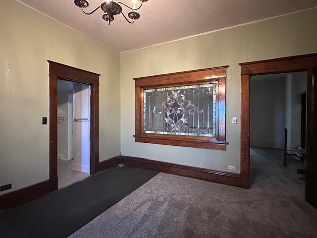 2311 30th St, Snyder, TX 79549 - carpeted empty room with a chandelier and baseboards