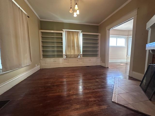 2311 30th St, Snyder, TX 79549 - unfurnished dining area featuring wood finished floors and crown molding