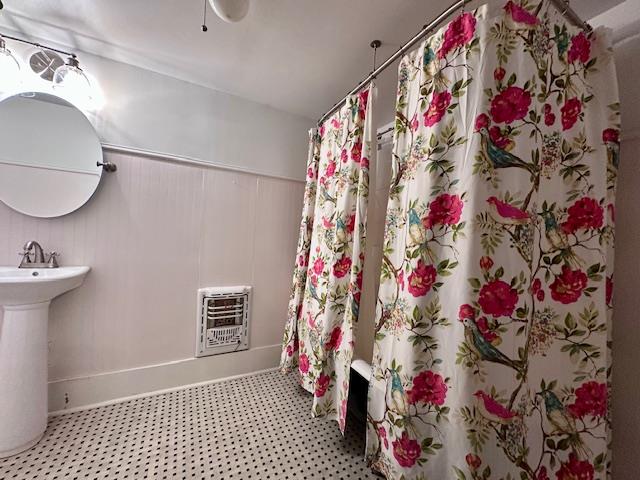 2311 30th St, Snyder, TX 79549 - full bath featuring heating unit and tile patterned floors