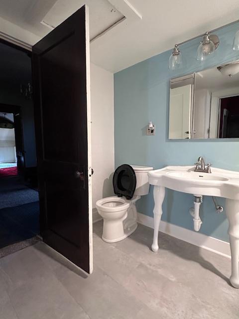 2311 30th St, Snyder, TX 79549 - bathroom featuring toilet and a sink