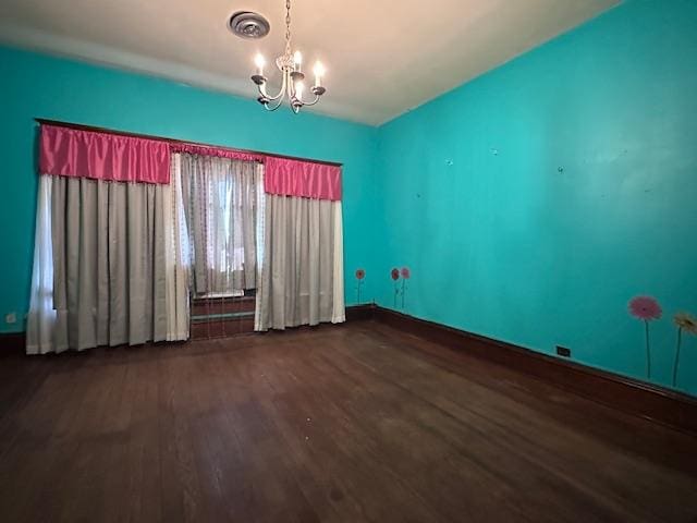 2311 30th St, Snyder, TX 79549 - spare room with wood finished floors and a chandelier