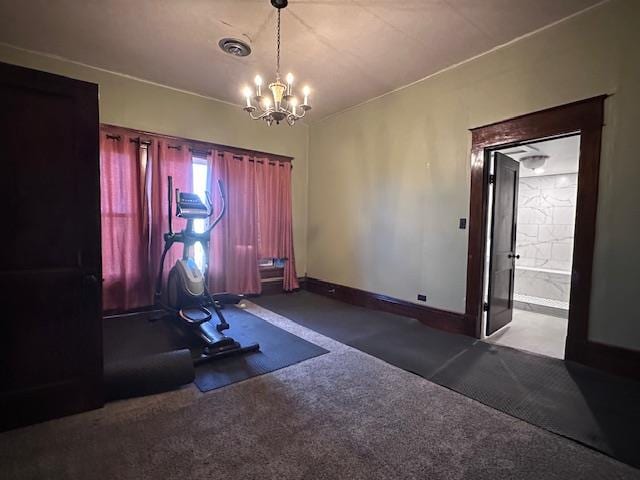 2311 30th St, Snyder, TX 79549 - workout room featuring a chandelier and carpet flooring
