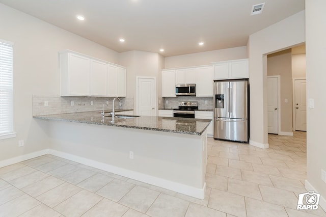 kitchen with white cabinetry, appliances with stainless steel finishes, and kitchen peninsula