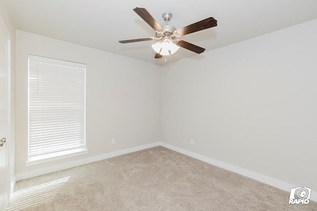 unfurnished room featuring light colored carpet and ceiling fan