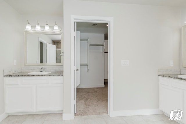 bathroom with vanity and tile patterned floors