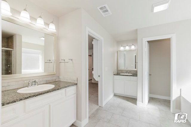 bathroom featuring an enclosed shower, vanity, and tile patterned floors