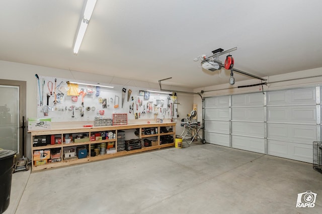 garage with a workshop area and a garage door opener