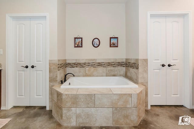 bathroom featuring a closet and a bath