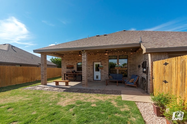 back of house featuring brick siding, a patio area, an outdoor living space, and roof with shingles