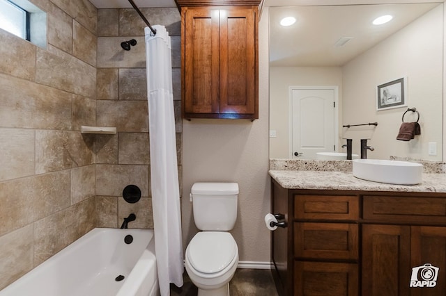 bathroom with toilet, vanity, shower / bath combo with shower curtain, and baseboards