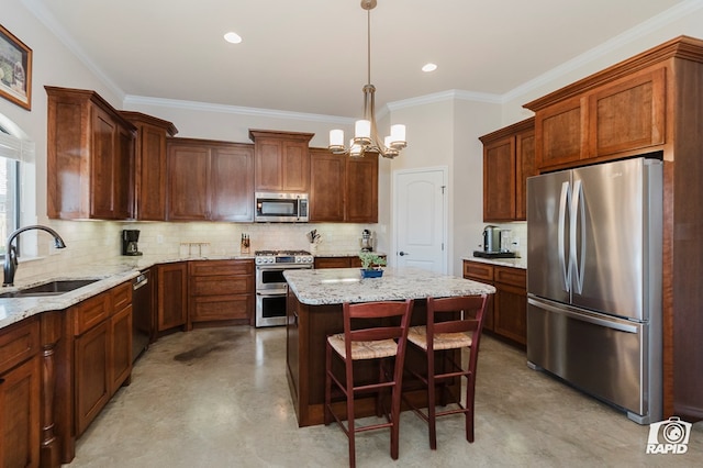 kitchen featuring appliances with stainless steel finishes, a sink, a kitchen island, a chandelier, and decorative backsplash