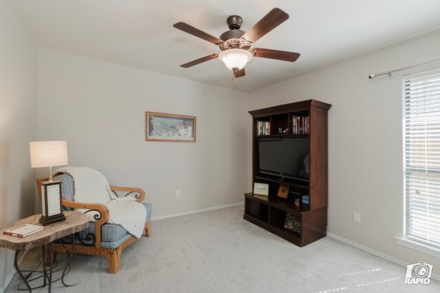living area featuring ceiling fan, carpet flooring, and baseboards