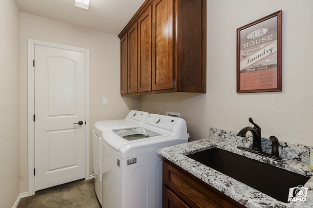 laundry room featuring washer and clothes dryer, cabinet space, and baseboards
